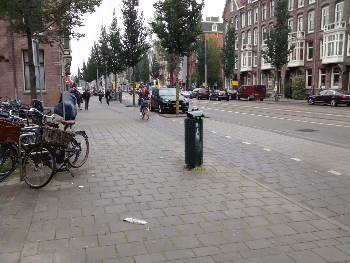 Image shows an animation switching between a photo of a Dutch street and a second where a UK style side road entrance is painted on the image.