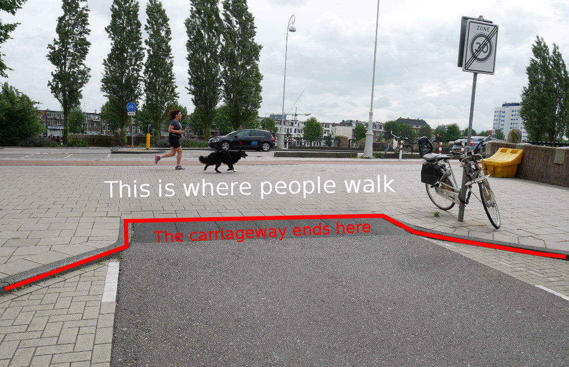Image shows a second photo of the continuous footway, but with lines and words drawn on it to highlight the way that people read what they see to understand how to behave.